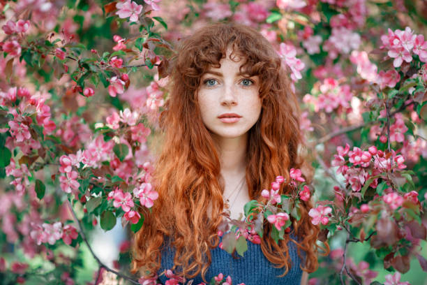 Beautiful young woman portrait with Spring Flowers