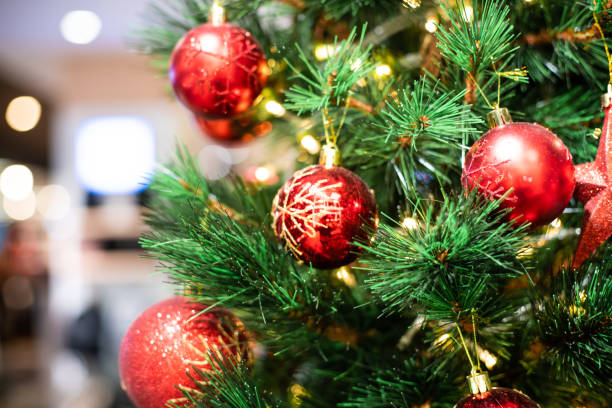 istock Christmas celebration concept with red ball hanging decorate gift on pine tree blurred background 1176368863