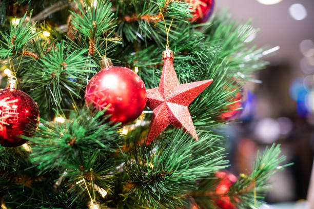istock Christmas celebration concept with red ball hanging decorate gift on pine tree blurred background 1176368867