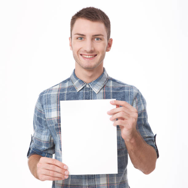 istock Young man holding white blank billboard close-up on white background. 1176371000