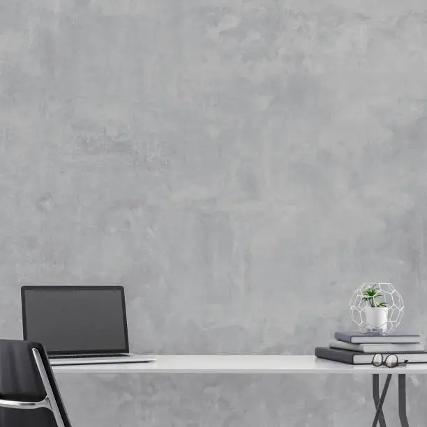 Workdesk with decoration in front of empty grey concrete wall with copy space. 3D rendered image.