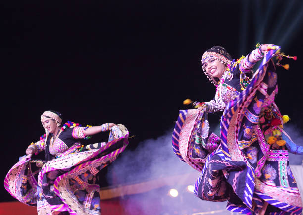 Indian dancers on Camel festival in Rajasthan state, India Bikaner, Rajasthan state, India - January 13, 2019: Indian women performing folk dance called Kalbeliya on Camel festival. Kalbelia is the one of the most sensuous dance forms of Rajasthan, performed by the Kalbelia tribe. india jaipur rajasthan traditional culture stock pictures, royalty-free photos & images