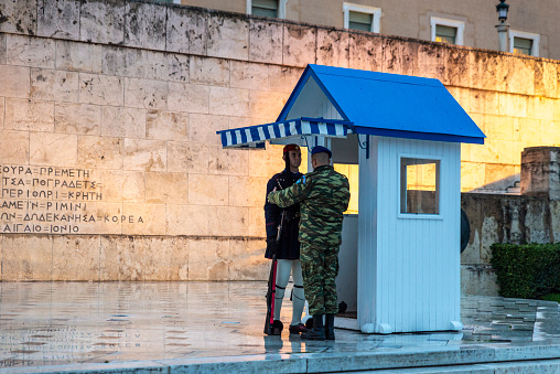 Athens, Greece - December 31, 2018: Greek Presidential Guard (Evzones) in front of the Hellenic Parliament and the Tomb of the Unknown Soldier in Athens, Greece