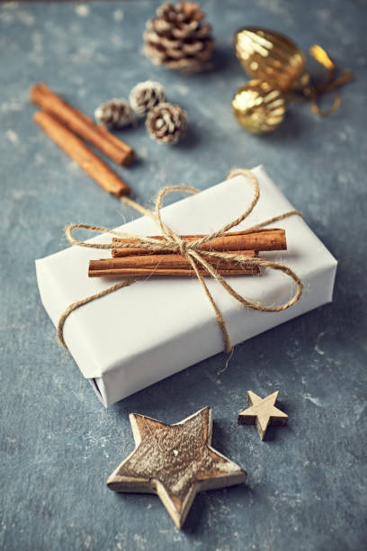 istock Christmas present decorated with cinnamon sticks on gray background 1176379998