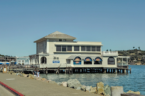 Sausalito, California, USA - September 21, 2019: These restaurants are located on Bridgeway along the edge of Sausalito Bay with the walkway and rocky waterfront making this popular for the many visitors to Sausalito just north of the Golden Gate Bridge and on this beautiful September day the first day of Fall it is a very enticing view everywhere you look.
