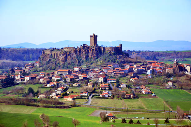 Fortress of Polignac and her village. Polignac, France - April 4th 2019 : Fortress of Polignac (a fortified castle) and her village. The place has been constructed on old volcanoes. auvergne rhône alpes photos stock pictures, royalty-free photos & images