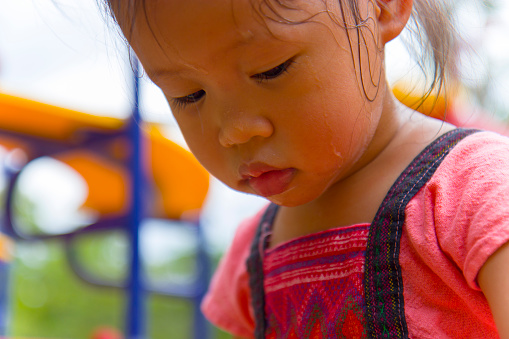 Toddler's Face looking for something and sweaty on her face .