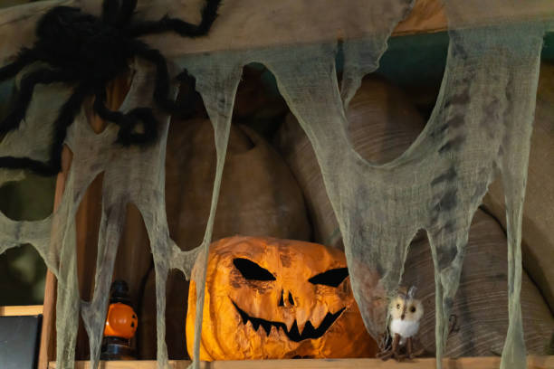 istock Halloween pumpkin head Jack lantern on old barn shelf 1176385515