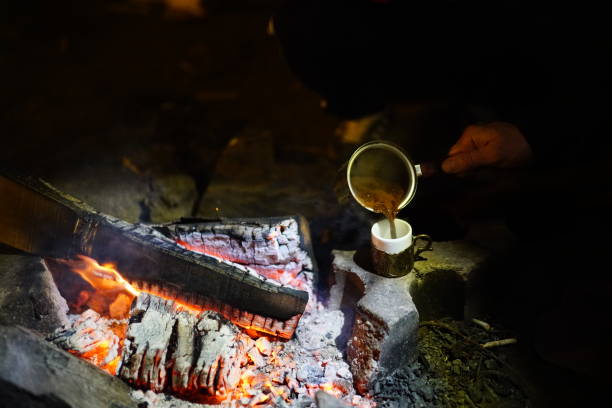 istock Boiling coffee in turkish cezva on campfire coals. Luxury camping concept. 1176386111