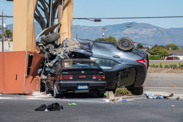 Distracted Driving Accident Salinas, California - July 27, 2019: An out of control car lands upside down on top of a parked car. pics of drunk driving accidents stock pictures, royalty-free photos & images