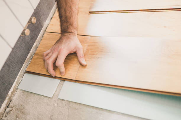 istock The builder is engaged in laying laminate in the room 1176386367