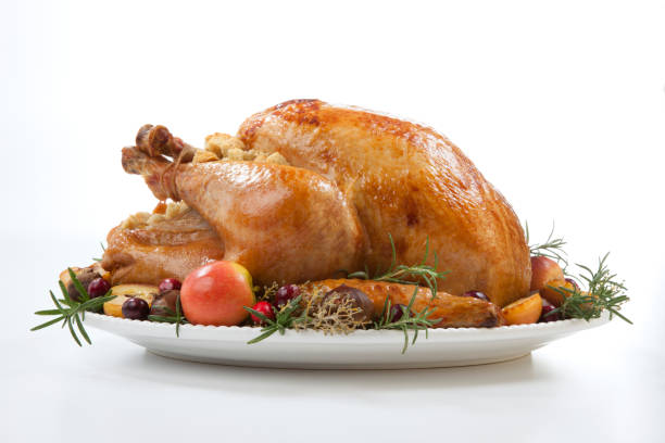 Roasted Turkey with Grab Apples over white Garnished roasted turkey with grab apples, sweet chestnut, and cranberry over white background remote location stock pictures, royalty-free photos & images