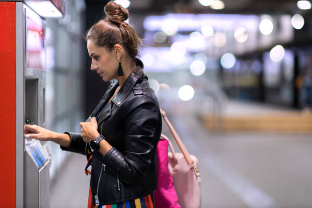 Young woman withdrawing money at an ATM
