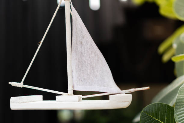 istock a small white sailboat toy hanging in the air with blurred background 1176390980
