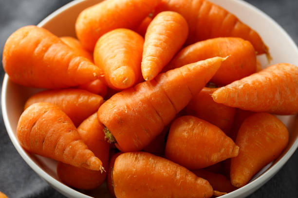istock Mini chantenay carrots in a white bowl 1176393680