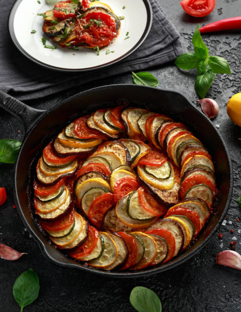 istock Ratatouille Vegetable Stew with zucchini, eggplants, tomatoes, garlic, onion and basil. on cast iron pan. Traditional French food. 1176393864