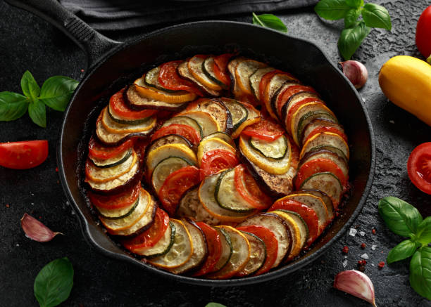 istock Ratatouille Vegetable Stew with zucchini, eggplants, tomatoes, garlic, onion and basil. on cast iron pan. Traditional French food. 1176393889