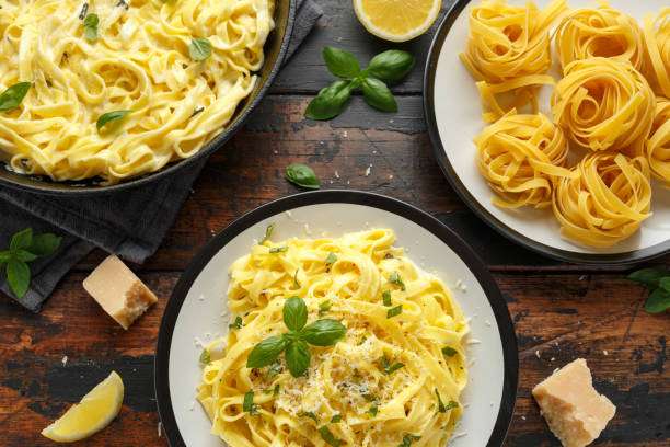 istock Pasta al Limone, Lemon with basil and parmesan cheese on wooden table 1176394545