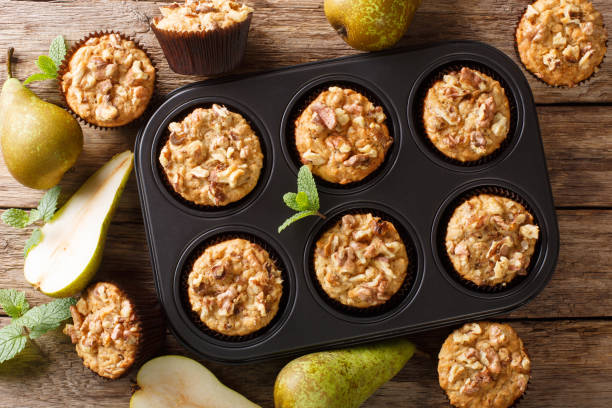 istock Healthy breakfast pear muffins with walnuts and oatmeal in a baking dish close-up. Horizontal top view 1176395140