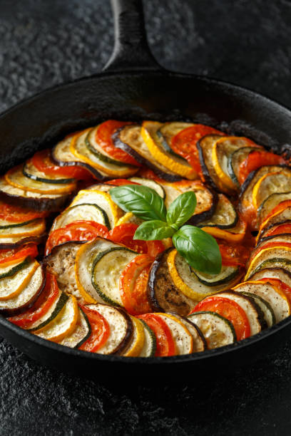 istock Ratatouille Vegetable Stew with zucchini, eggplants, tomatoes, garlic, onion and basil. on cast iron pan. Traditional French food. 1176395265