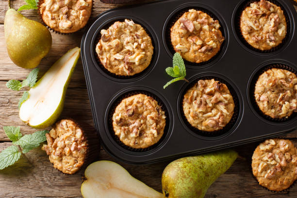 istock Dietary delicious pear muffins with walnuts and oatmeal in a baking dish close-up. Horizontal top view 1176395330