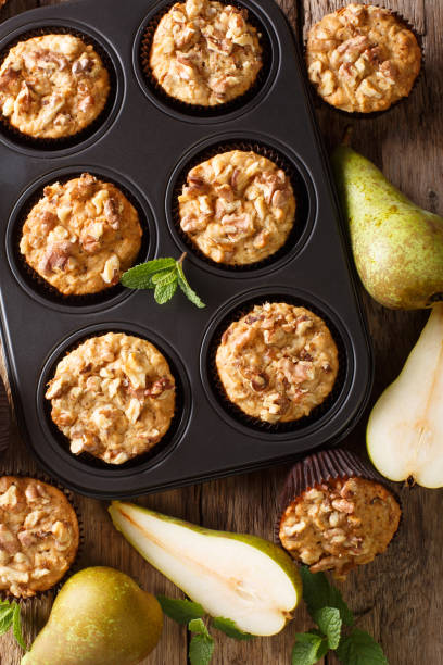 istock pear muffin with cinnamon and walnuts in a baking dish close-up. Vertical top view 1176395467