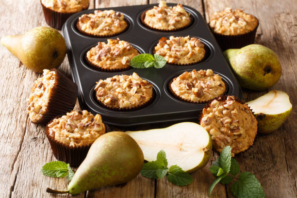 istock Only from the oven pear muffins with walnuts, cinnamon and nutmeg in a baking dish close-up. horizontal 1176395490