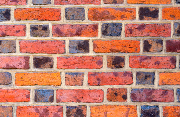 istock Brick wall made of red, black and orange bricks. Great background for design. 1176395698