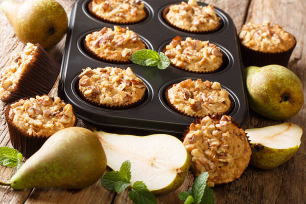 istock Healthy breakfast pear muffins with walnuts and oatmeal in a baking dish close-up. horizontal 1176396081