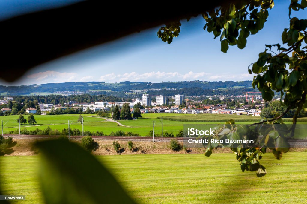 Uzwil in sunny weather. View of Uzwil, a small town in Switzerland in sunny weather. Agricultural Field Stock Photo