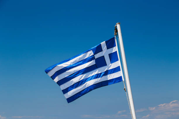 istock Greek flag on the blue sky background 1176398699