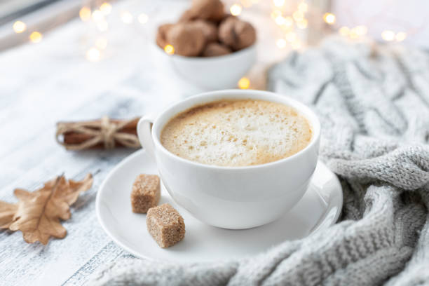 istock Coffee mug, sweater, cinnamon, decorated with led lights. Autumn mood. Cozy autumn composition. Hygge concept Soft focus 1176398791