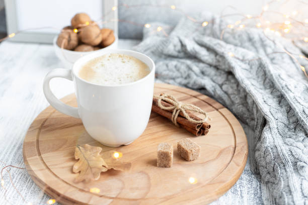 istock Coffee mug, sweater, cinnamon, decorated with led lights. Autumn mood. Cozy autumn composition. Hygge concept Soft focus 1176398797