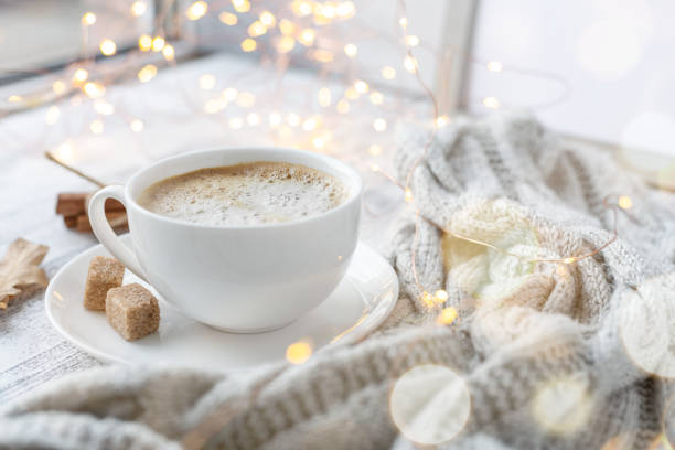 istock Coffee mug, sweater, cinnamon, decorated with led lights. Autumn mood. Cozy autumn composition. Hygge concept Soft focus 1176398799