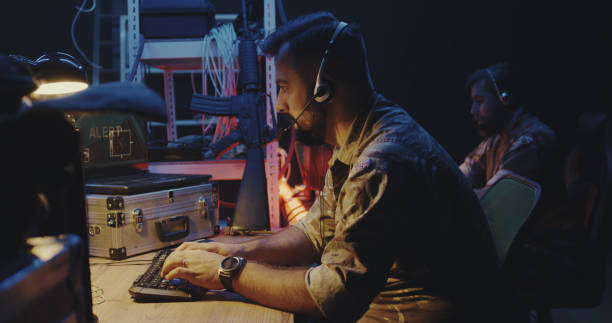 istock Soldier following car movement on computer 1176398937
