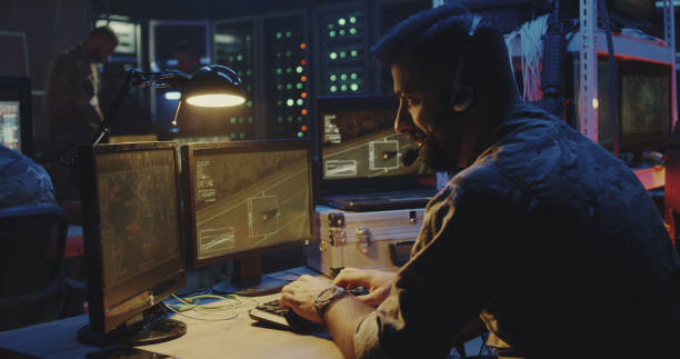 istock Soldier following car movement on computer 1176398952