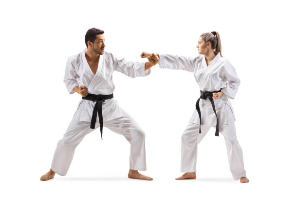 istock Man and woman with black belts in karate fighting 1176399998