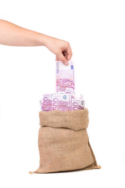 istock Hand pulls money out of the bag. 1176402035