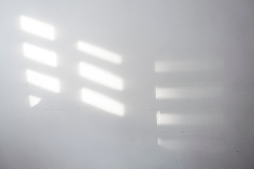 shadow on wall from wooden blind