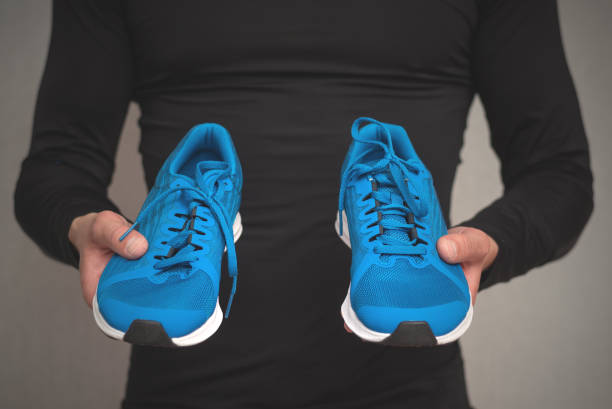 istock New sneakers in male hands. 1176402408
