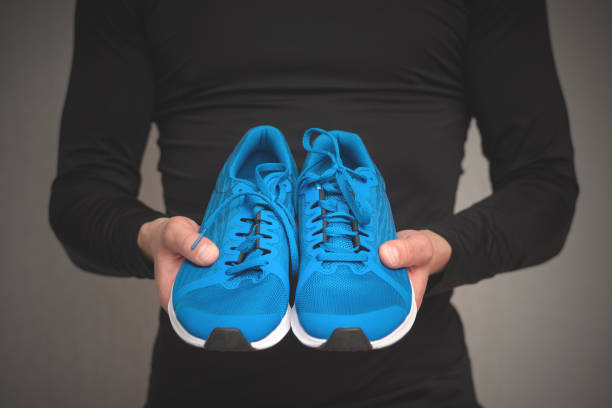 istock New sneakers in male hands. 1176402419