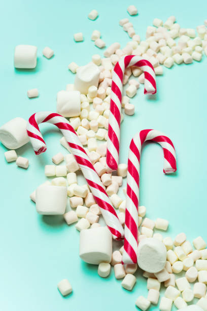istock Christmas or New year holiday layout with candy canes and marshmallows. 1176403638