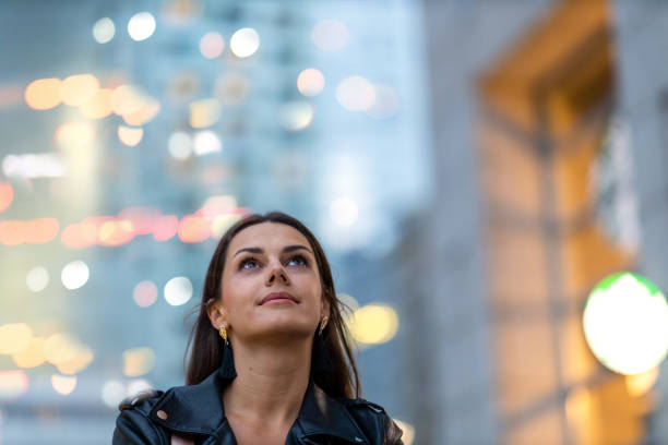 istock Young woman in city after dark 1176404828