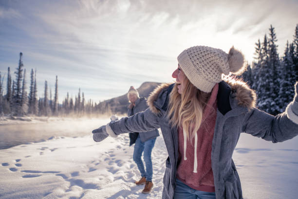 istock Playful couple snowball fighting in winter 1176409072
