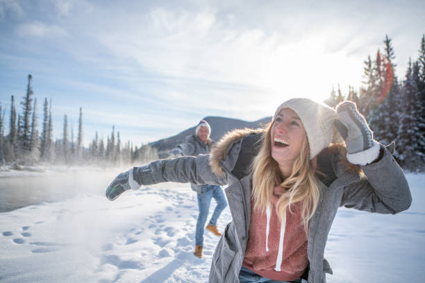 istock Playful couple snowball fighting in winter 1176409415