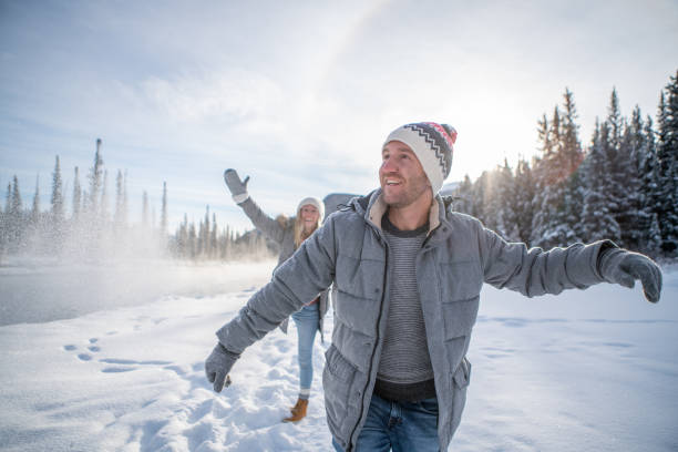 istock Playful couple snowball fighting in winter 1176409514