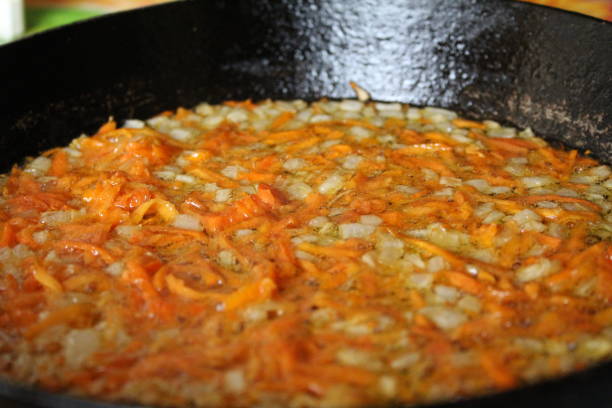 istock fried onions and carrots in a skillet 1176410673