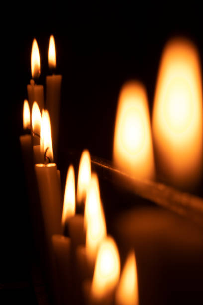votive candles lit in a church