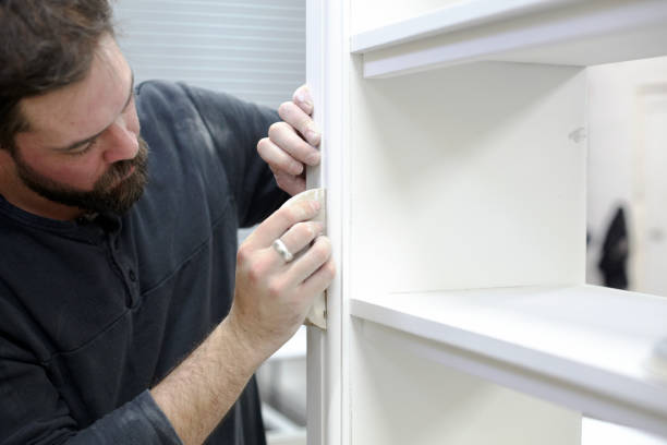 istock Carpenter Sanding Newly Made Cupboard For Painting 1176413205