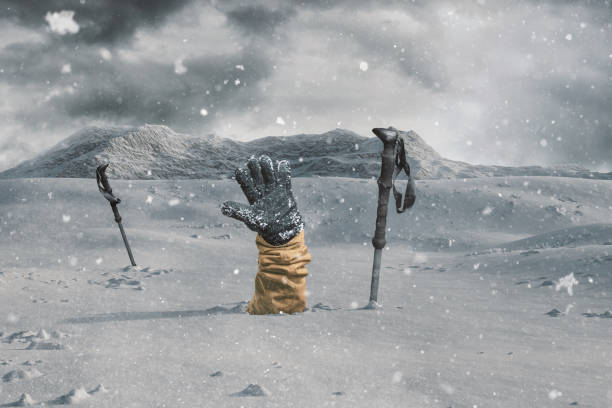 hiker stretching out his snow covered hand next to trekking poles to signal help because of snow avalanche . danger extreme concept - snow digging horizontal people imagens e fotografias de stock